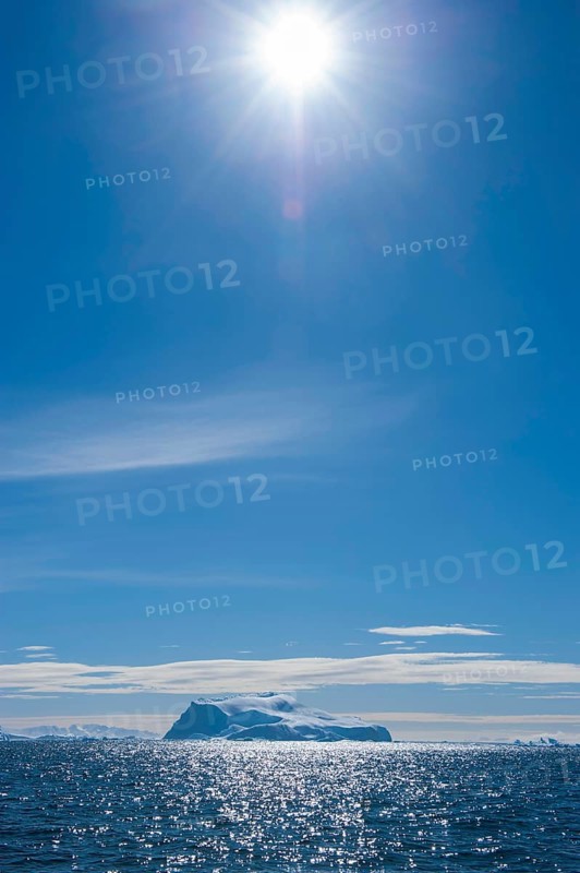 Sun shining over an iceberg