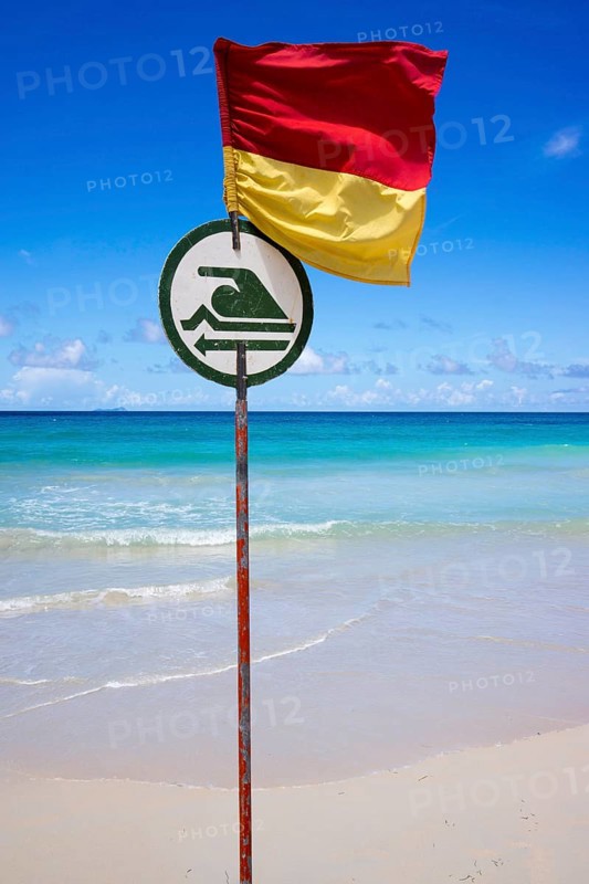 Dangerous beach with a flag indicating where bathing and swimming is possible
