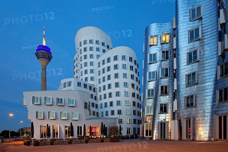 Rheinturm or Rhine Tower with two of the Gehry buildings at Neuer Zollhof
