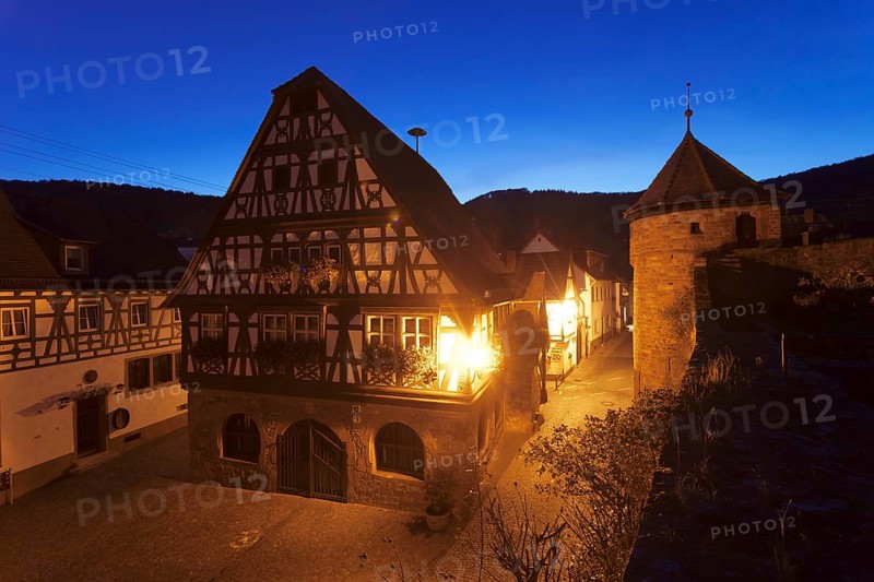 Historical Town Hall with a fortified wall and the tower of a fortified church