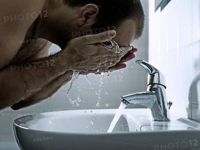Man washing his face with both hands