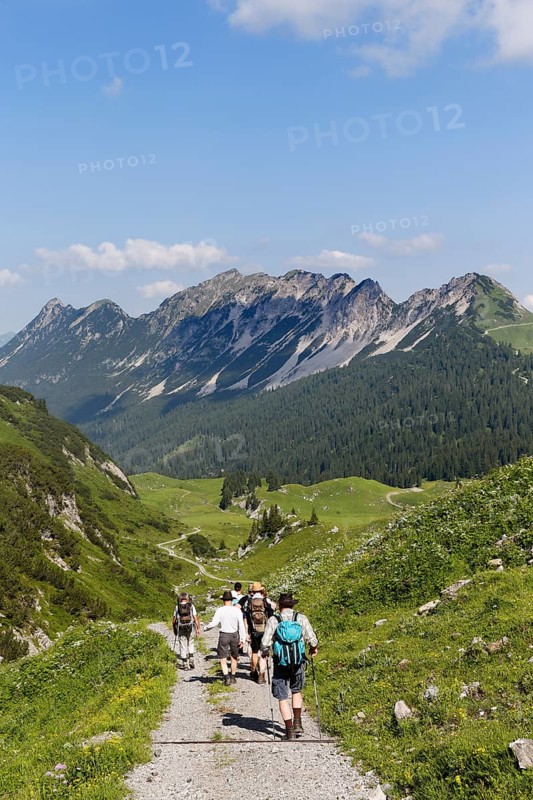 Hikers hiking above the Laguz Alps and Breithorn Mountain