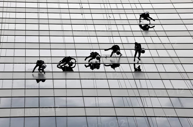 Window cleaners cleaning a glass facade