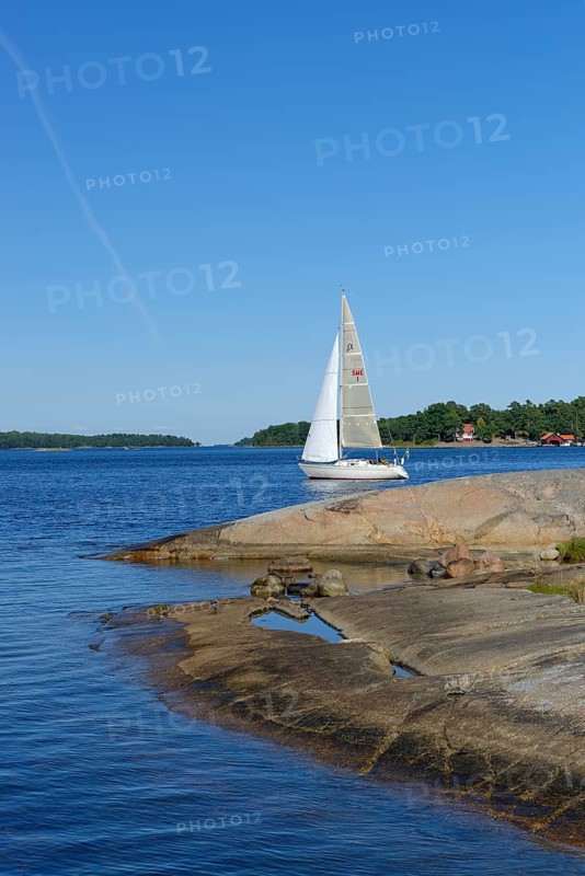 Sailboat and typical round polished rocks