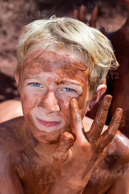 Boy applying healing earth