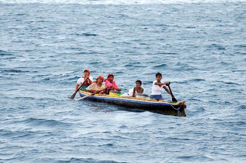 Kuna Indian women in a dugout canoe