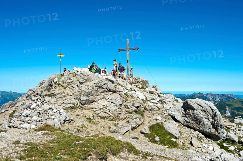 Rest at the summit cross on the Augstenberg mountain