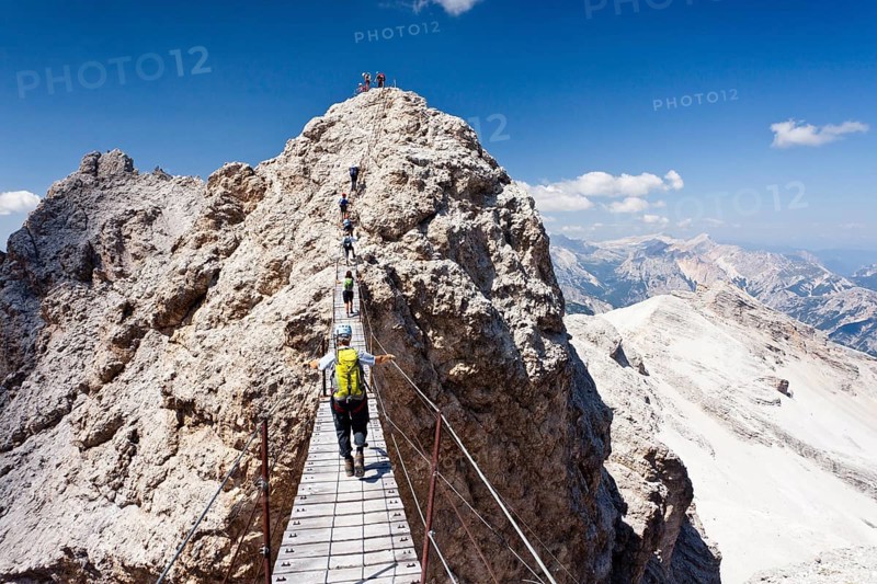 Mountain climbers ascending Cristallino Mountain on the Via Ferrata Ivano Dibona climbing route on Monte Cristallo