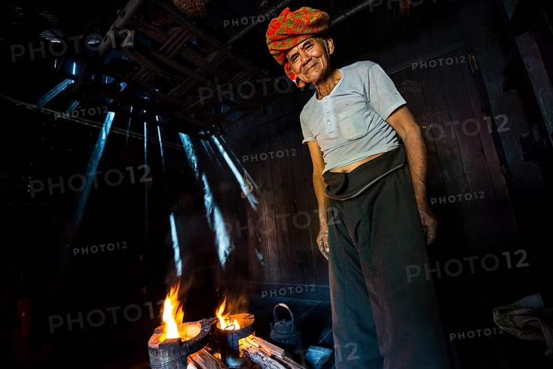 Elderly man at an open fire in the hut