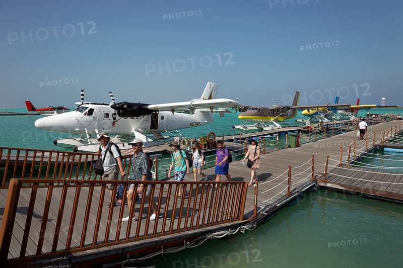 Tourists leaving the pontoon with hydroplanes moored