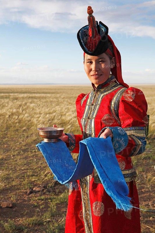 Woman in traditional dress with traditional welcome utensils