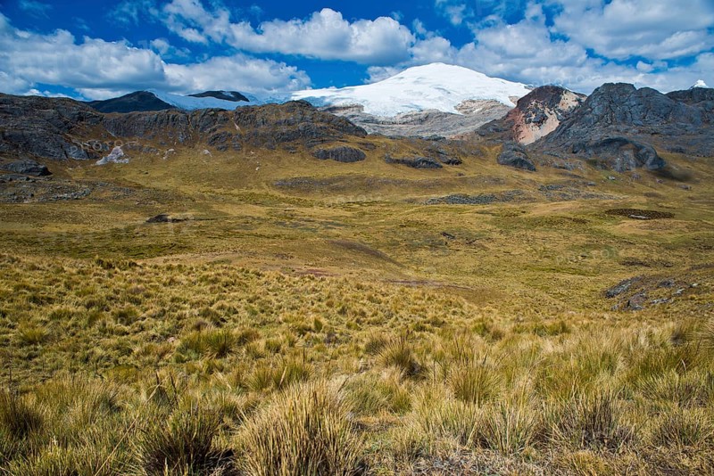 Snow-capped mountain peak rising over a high valley