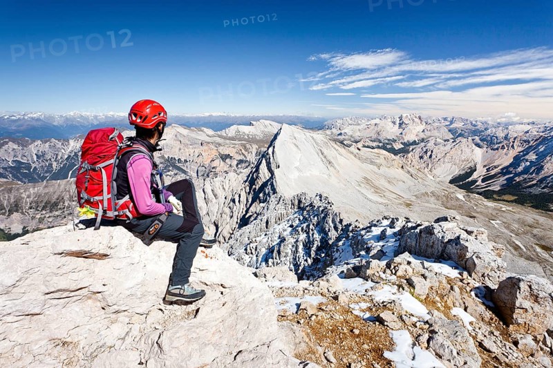 Mountain climber on the peak of Zehnerspitze Mountain in the Fanes Group