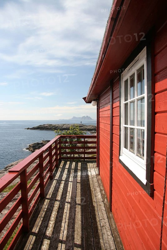 Typical Norwegian red wooden house by the sea