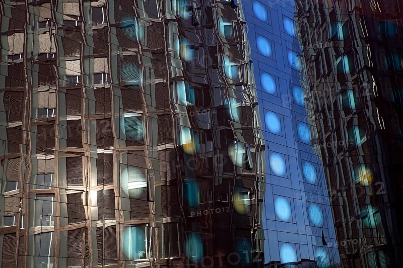 Tanzende Turme office building reflected in the facade of the Arcotel Onyx Hotel