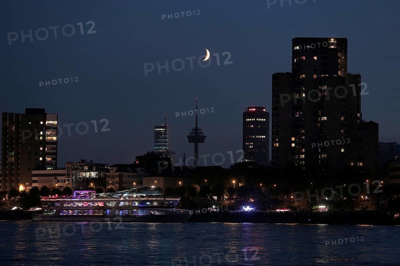 Cologne on the Rhine River with a crescent moon