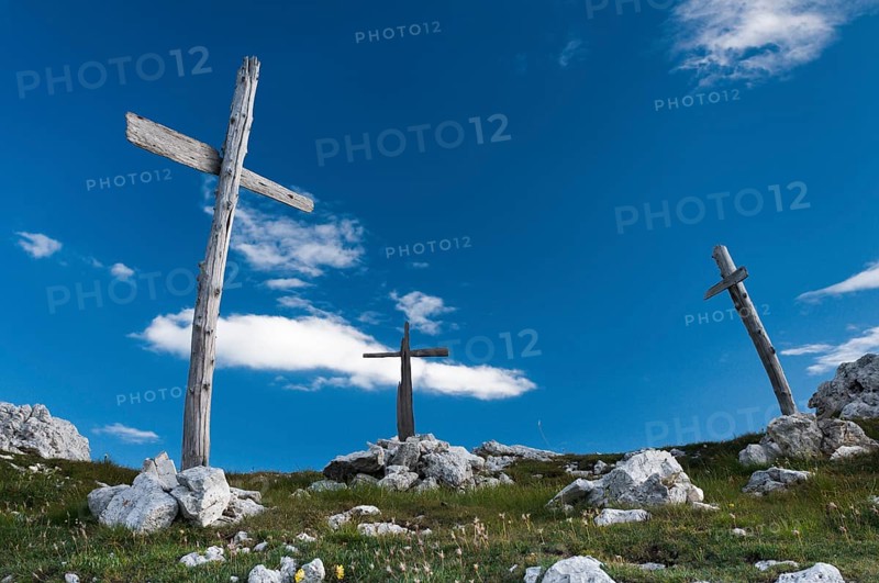 Three simple wooden crosses from World War I on a hill