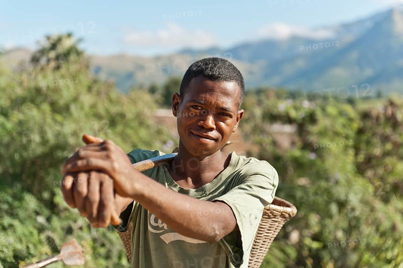 Young man of the Antandroy people carrying a basket for field work