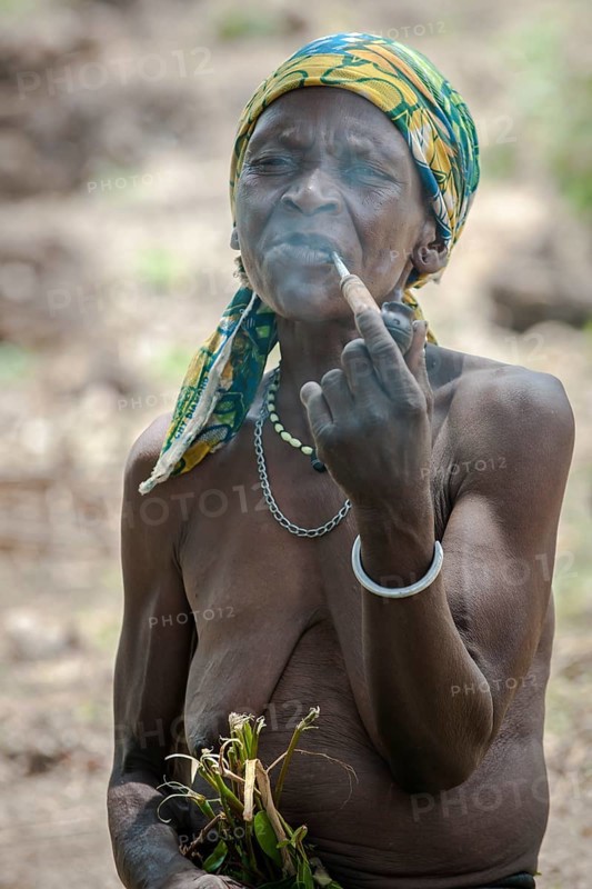 A woman from the Koma people smoking a pipe