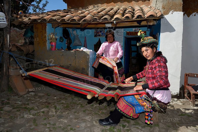 Young woman weaving traditional cloth at the loom
