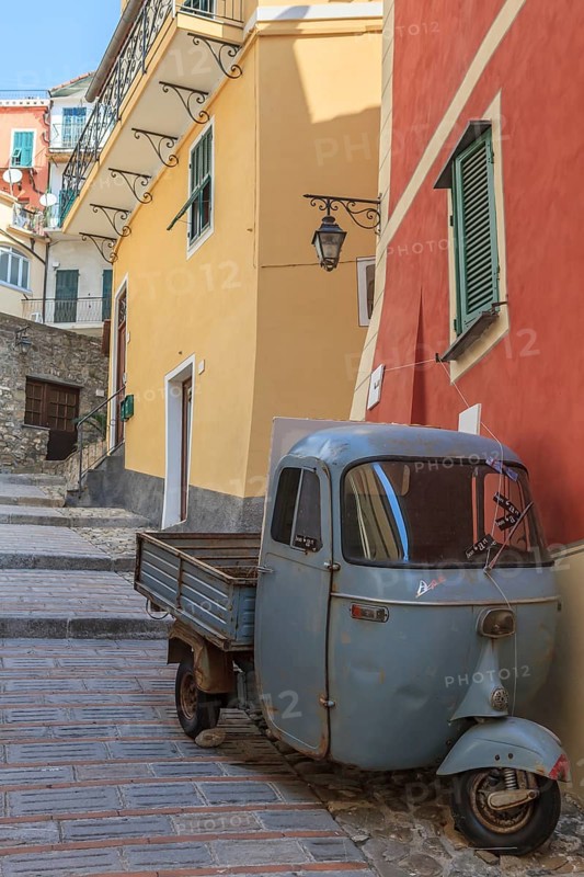 Typical Italian three-wheeled light commercial vehicle parked in an alley