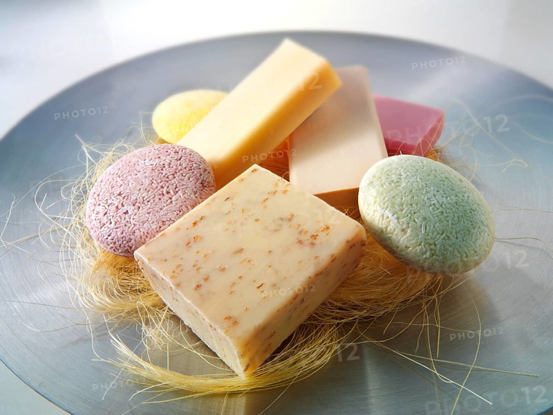 Selection of natural hand made soap bars piled on a dish