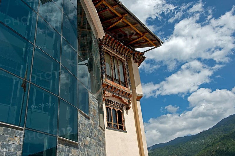 Modern glass facade and traditional-style windows at the headquarters of the Royal University of Bhutan