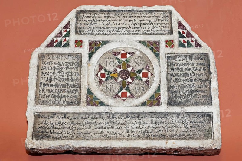 Stone with inscriptions in four languages