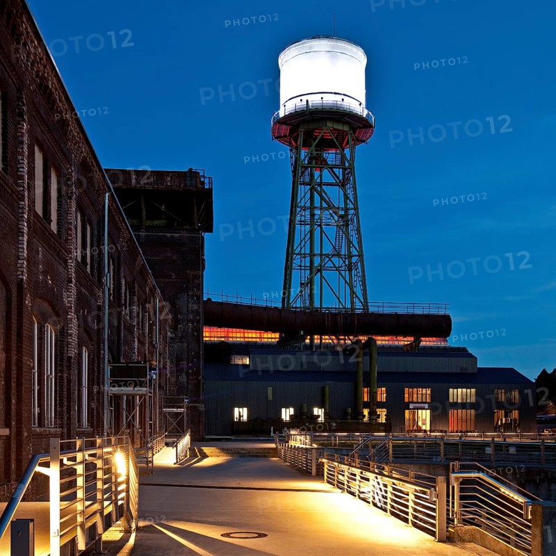 Jahrhunderthalle or Centennial Hall with a water tower at dusk