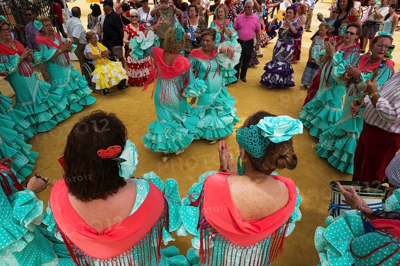 Women wearing gypsy dresses perform traditional Andalusian dances at the Feria del Caballo