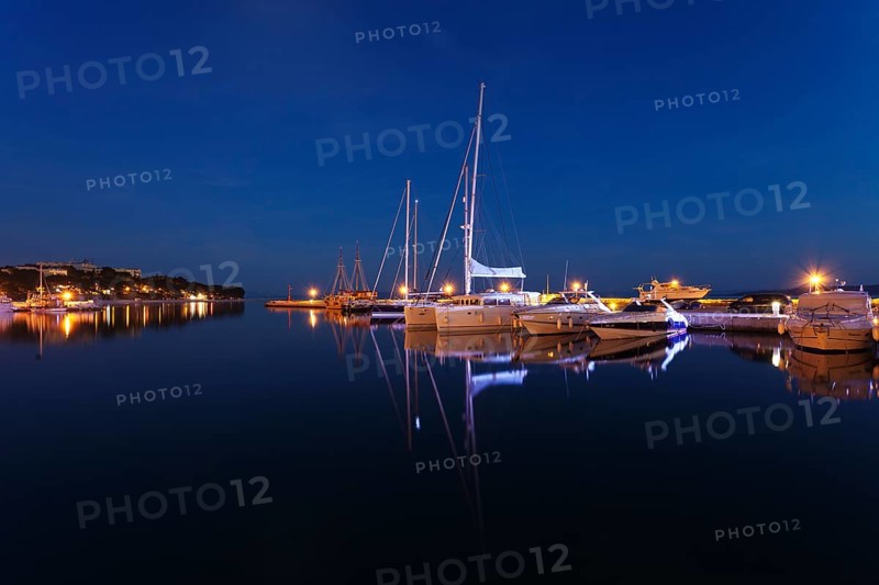 Boats reflected in the water at night