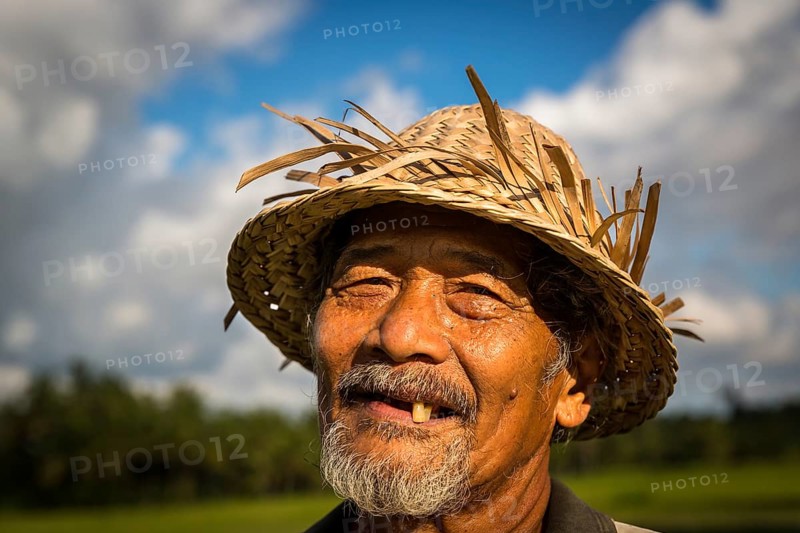 Elderly rice farmer wearing a straw hat