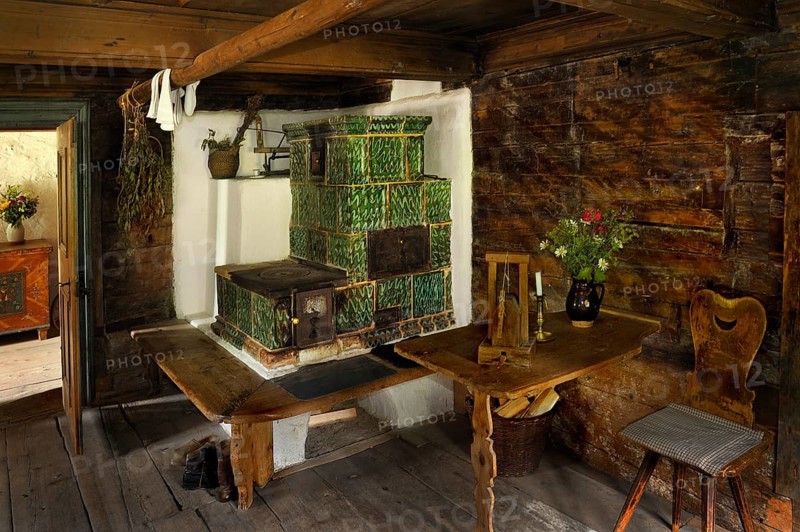 Living room with a tiled stove in Markus Wasmeier Farm and Winter Sports Museum