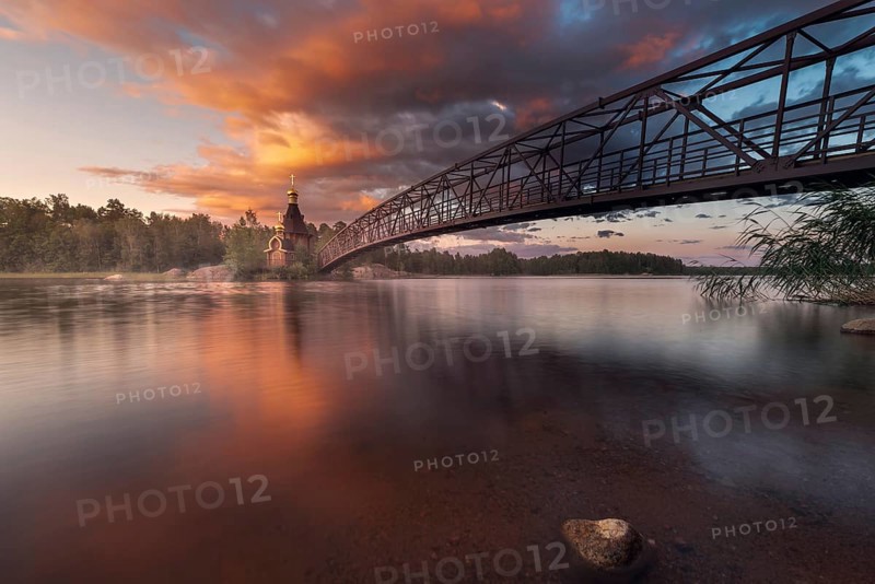 Bridge and Church of St. Andrew at Vuoksi River during sunset