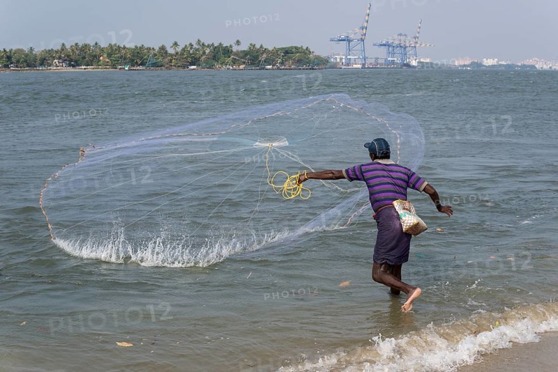 A fisherman throwing his net