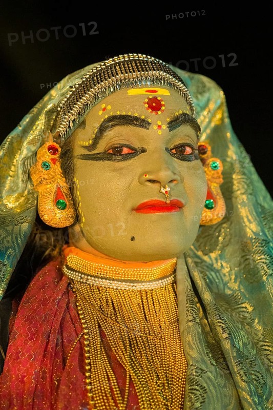 Kathakali dancer in full makeup wearing a costume