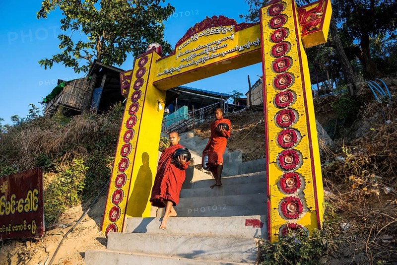 Buddhist novices with begging bowls at their morning begging tour
