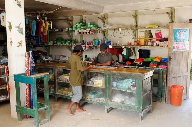 Kuna Indian men in a store in a Kuna Indian village