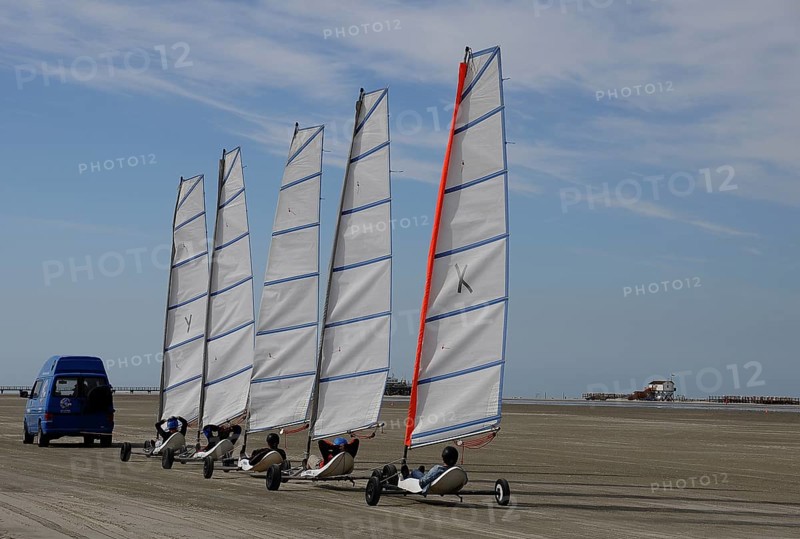 Land yachts being pulled to the beach by a car