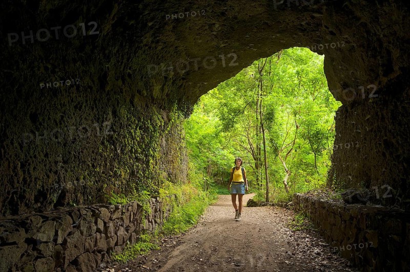 Hiker in a rock tunnel