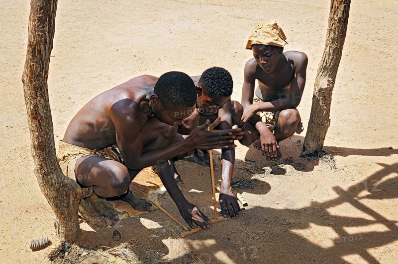 Three local men making fire