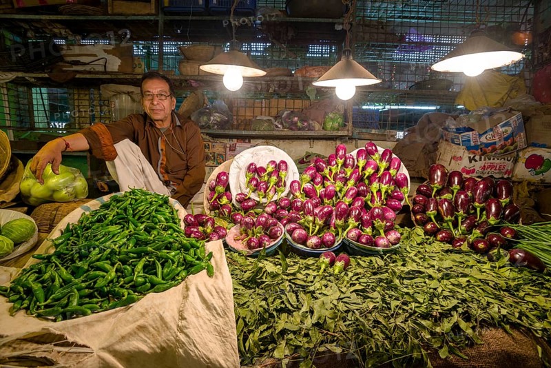Man selling vegetables at a vegetable market