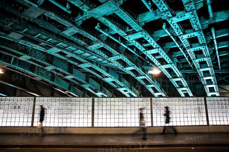 Pedestrians in an illuminated underpass