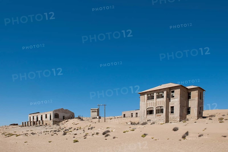 Houses of a former diamond miners settlement that is slowly covered by the sand of the Namib Desert