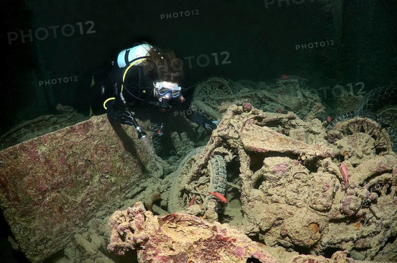 Scuba diver looking at Norton 16H motorcycle
