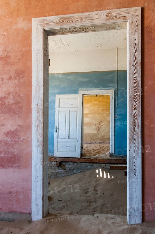 Wind-borne sand in a house of the former diamond miners settlement that is slowly covered by the sand of the Namib Desert