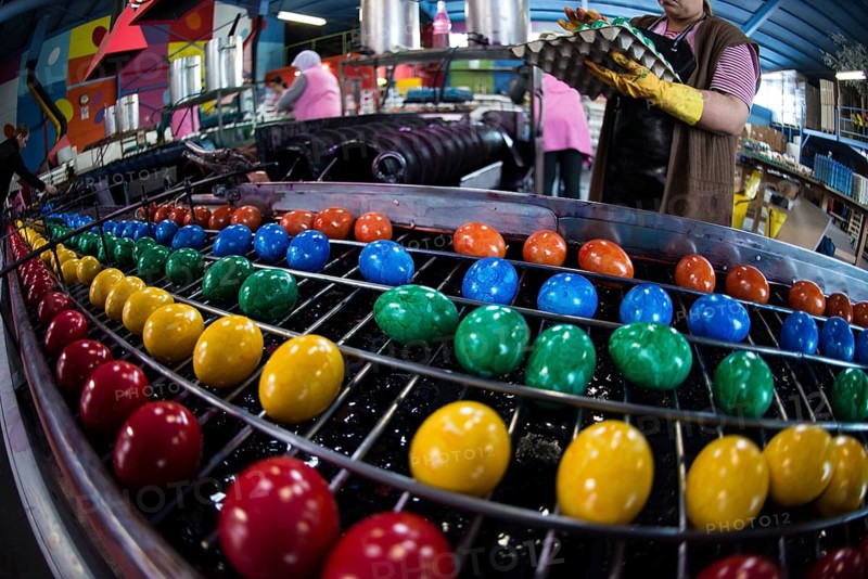 Brightly coloured Easter eggs on a conveyor belt