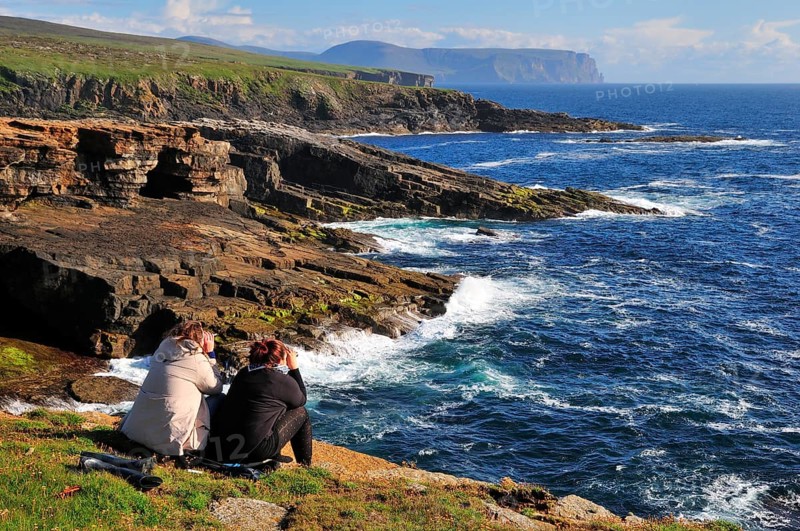 Two female tourists on the lookout with binoculars
