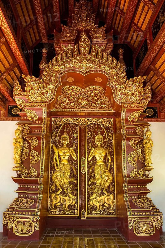 Teak entrance gate decorated with gold leaf in Wat Phrah Singh Temple