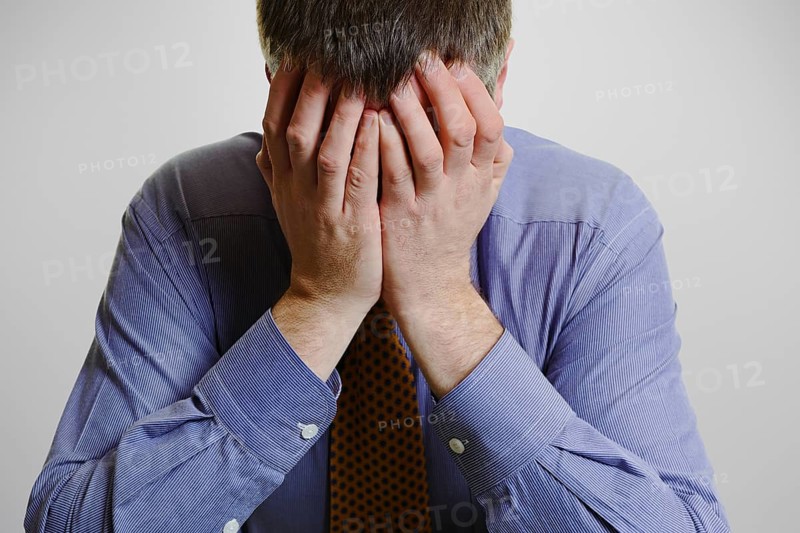 Businessman with his head in his hands